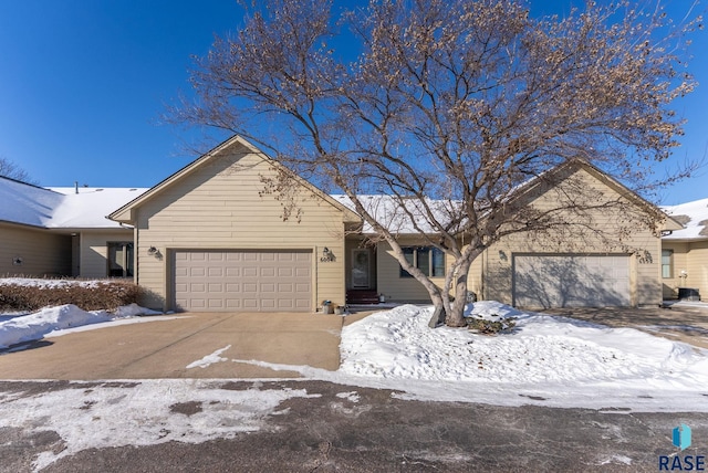 ranch-style home featuring a garage and driveway