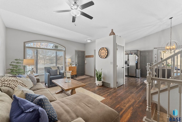 living room with ceiling fan with notable chandelier, baseboards, vaulted ceiling, stairway, and dark wood finished floors