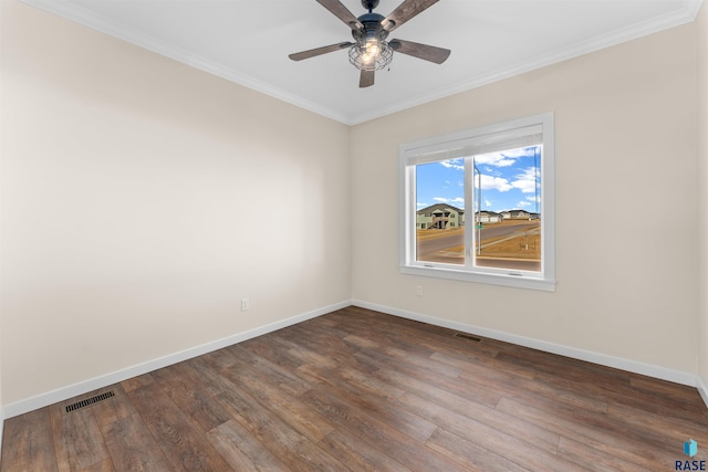 unfurnished room featuring baseboards, visible vents, dark wood-type flooring, and ornamental molding