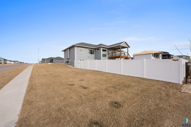 exterior space featuring a residential view and fence