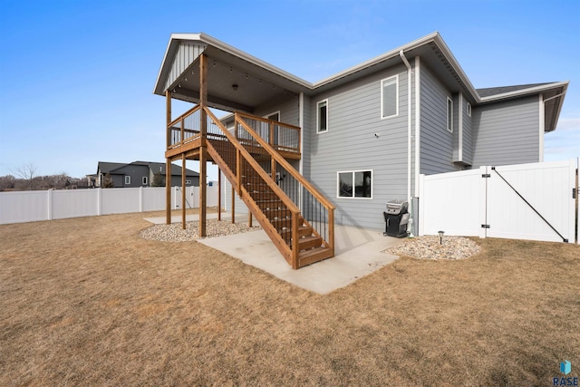 back of house with a patio, a fenced backyard, stairway, a gate, and a wooden deck