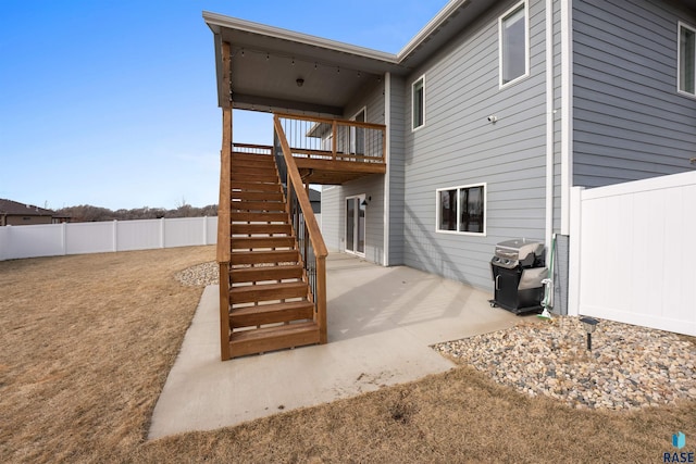 rear view of house with a patio area, a fenced backyard, and stairway