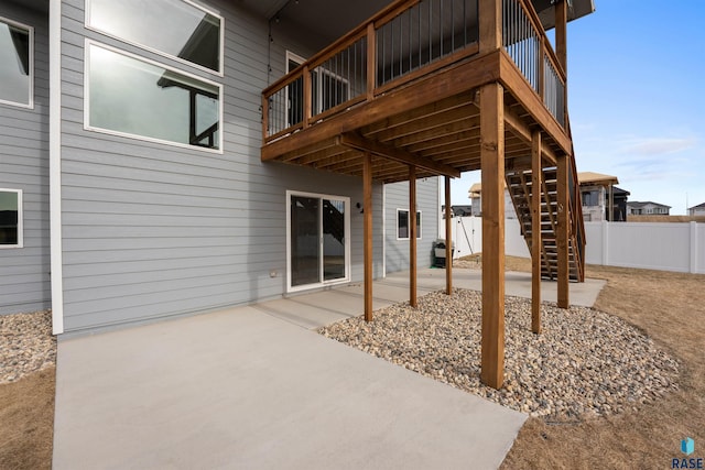 view of patio / terrace featuring stairway and fence