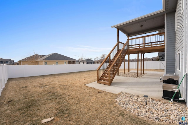 view of yard featuring a fenced backyard, a patio, and stairs