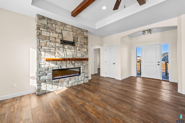 unfurnished living room with dark wood-style floors, a fireplace, and baseboards