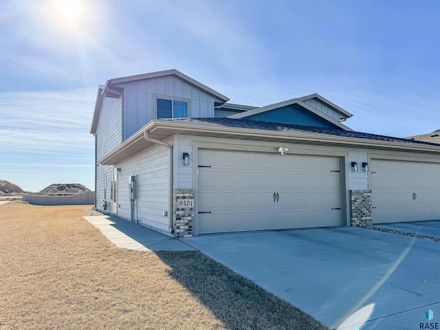 view of front of property featuring concrete driveway, board and batten siding, and an attached garage