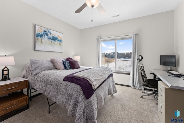 bedroom featuring visible vents, a ceiling fan, and light colored carpet