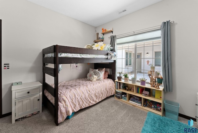 carpeted bedroom featuring visible vents and baseboards