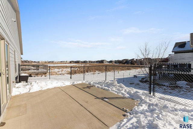 snowy yard featuring fence