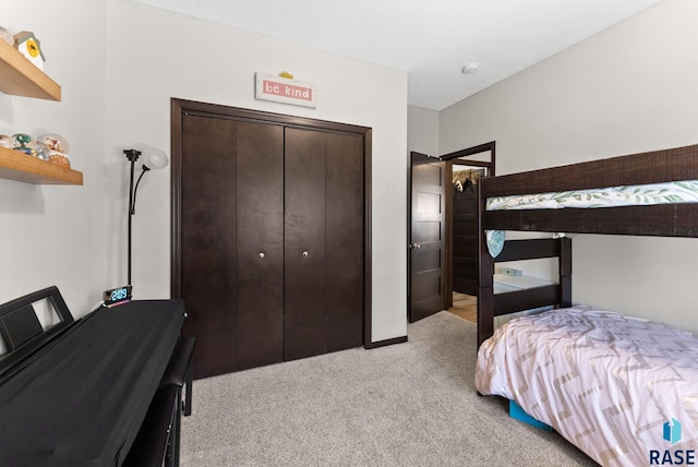 bedroom with a closet and light colored carpet