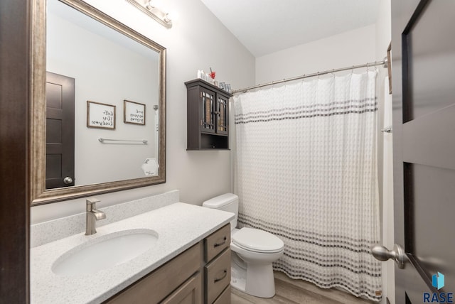 full bathroom with toilet, wood finished floors, and vanity