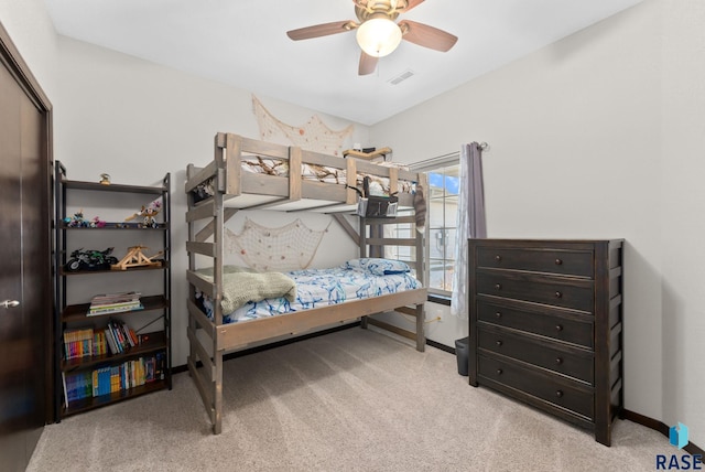 bedroom with visible vents, ceiling fan, light carpet, and baseboards