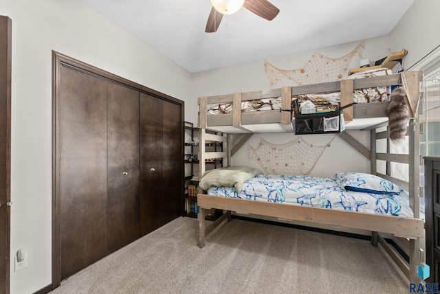 carpeted bedroom featuring ceiling fan and a closet