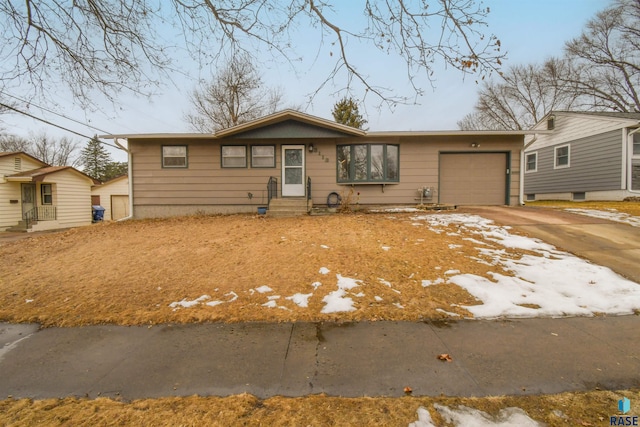 view of front facade with entry steps, an attached garage, and concrete driveway