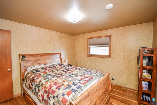 bedroom featuring dark wood finished floors