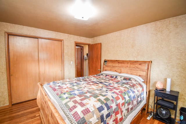 bedroom featuring a closet and wood finished floors