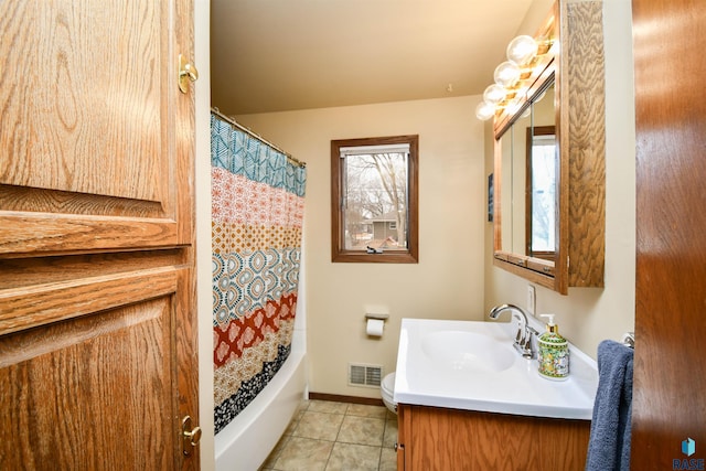 full bathroom featuring tile patterned flooring, shower / tub combo, vanity, visible vents, and baseboards