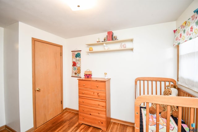 bedroom with dark wood finished floors and baseboards