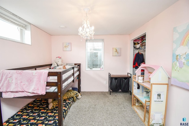 carpeted bedroom featuring an inviting chandelier