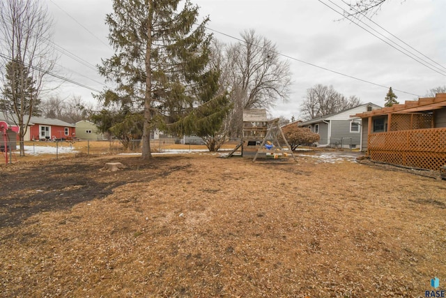 view of yard with fence and a playground