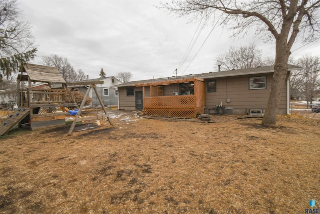 rear view of property featuring a wooden deck