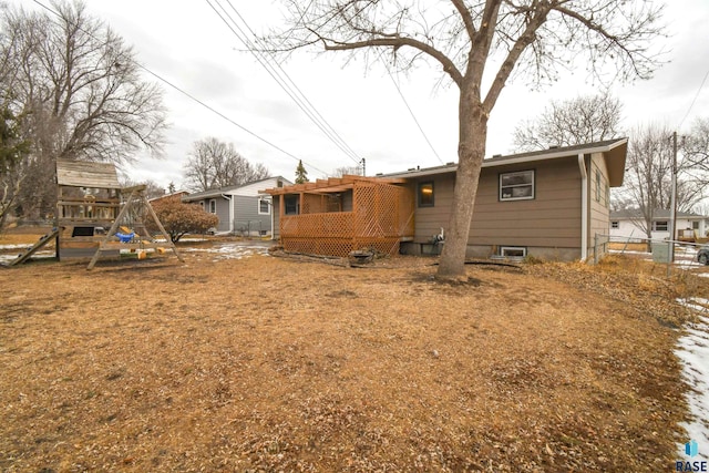 back of house featuring a playground