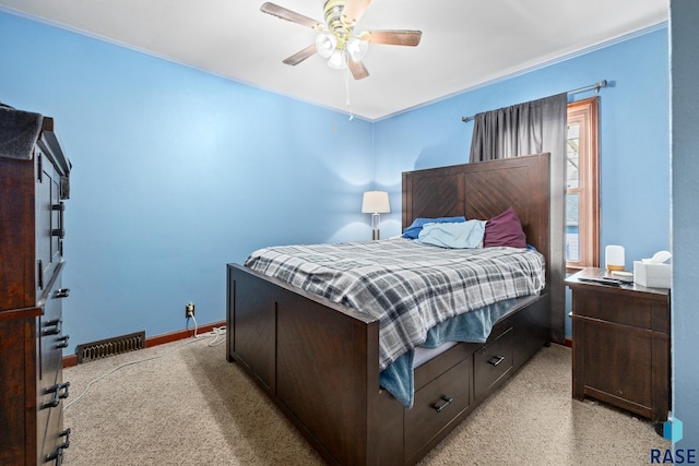 bedroom with a ceiling fan, light colored carpet, visible vents, and baseboards