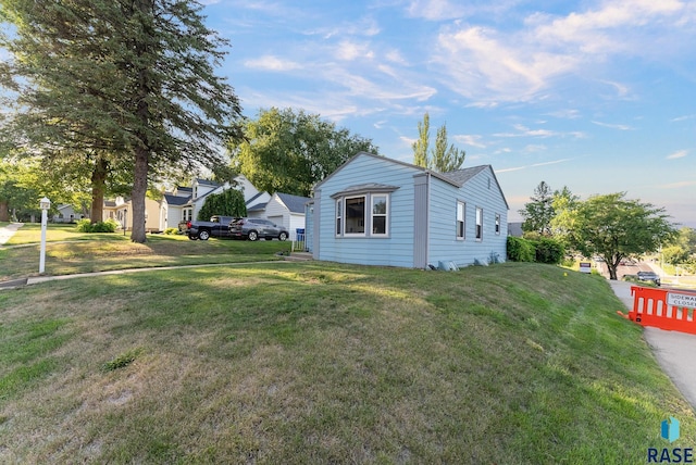 view of side of home featuring a residential view and a yard