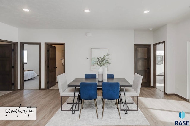 dining room featuring baseboards, light wood-type flooring, and recessed lighting