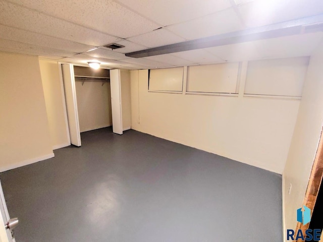 finished basement featuring a drop ceiling and visible vents