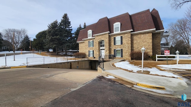 exterior space with fence and brick siding