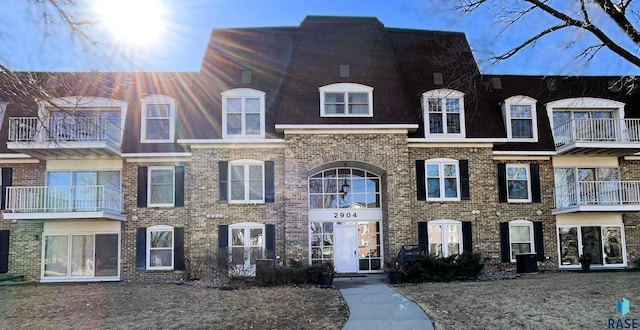 townhome / multi-family property featuring brick siding