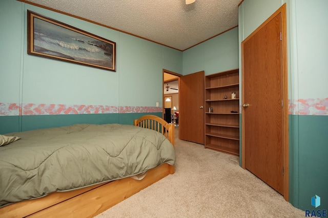 bedroom with light carpet, crown molding, and a textured ceiling