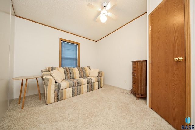 living area with light colored carpet, crown molding, and a textured ceiling