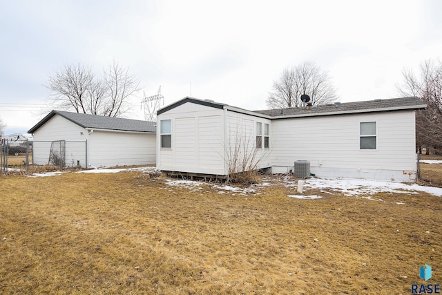 back of house with a yard, central AC unit, and fence