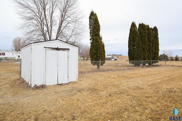 view of shed featuring fence