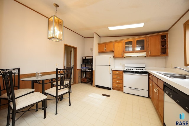 kitchen featuring light countertops, hanging light fixtures, a sink, white appliances, and under cabinet range hood