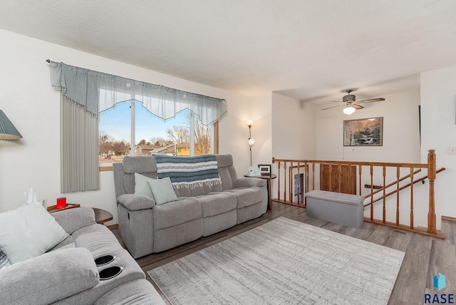 living area with a textured ceiling and wood finished floors