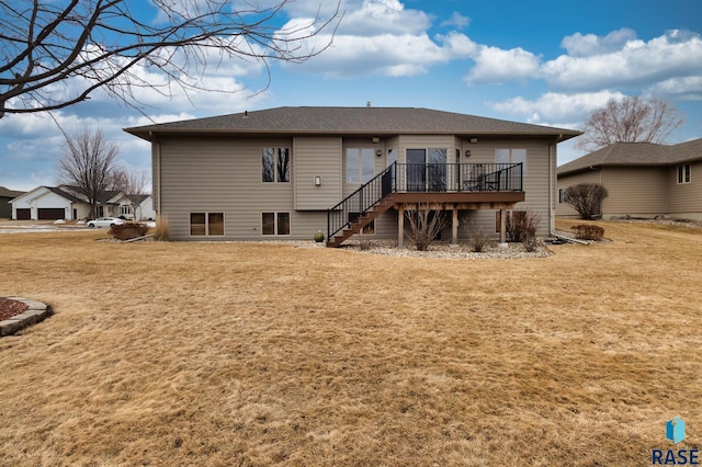 rear view of house with stairs, a deck, and a yard