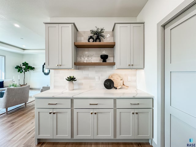 bar featuring recessed lighting, backsplash, and light wood finished floors