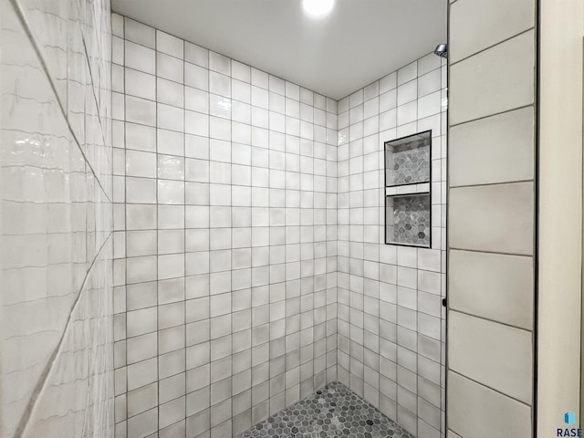 bathroom with a tile shower