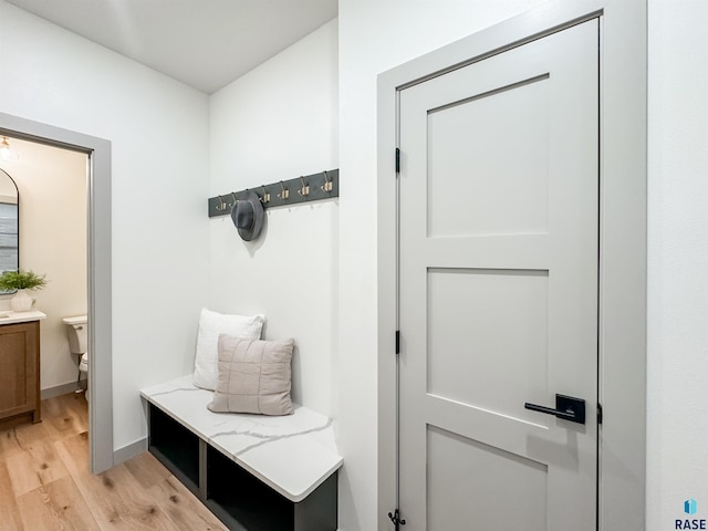 mudroom with baseboards and light wood finished floors