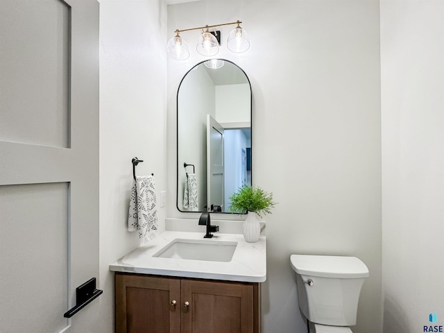 half bathroom with toilet and vanity