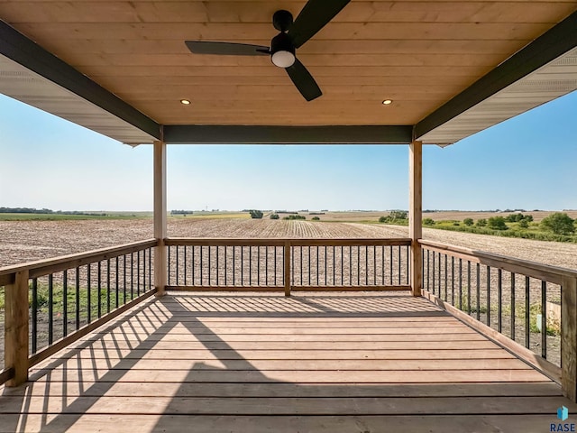 deck with a rural view and ceiling fan