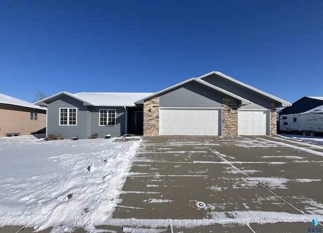 ranch-style house with stone siding and an attached garage