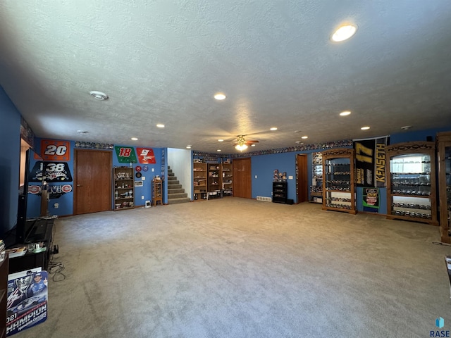 interior space with a textured ceiling, stairway, carpet, and recessed lighting