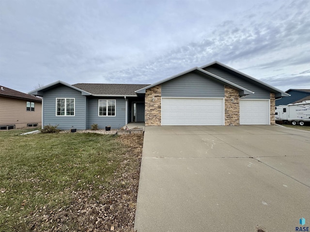 ranch-style home featuring an attached garage, driveway, stone siding, roof with shingles, and a front yard