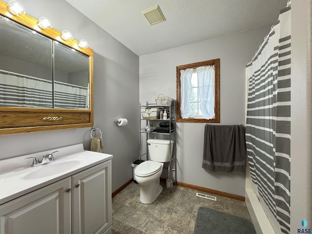 bathroom featuring toilet, vanity, visible vents, and baseboards