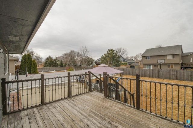 wooden terrace featuring a residential view, a fenced backyard, and a gazebo