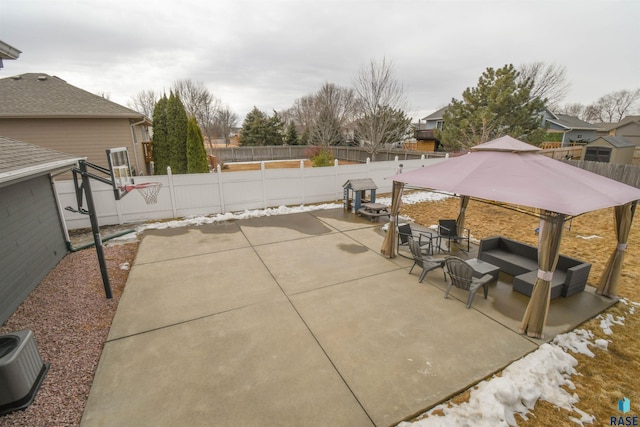 view of patio featuring a fenced backyard, an outdoor living space, central AC, and a gazebo